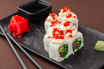 sushi on a black plate