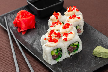 sushi on a black plate