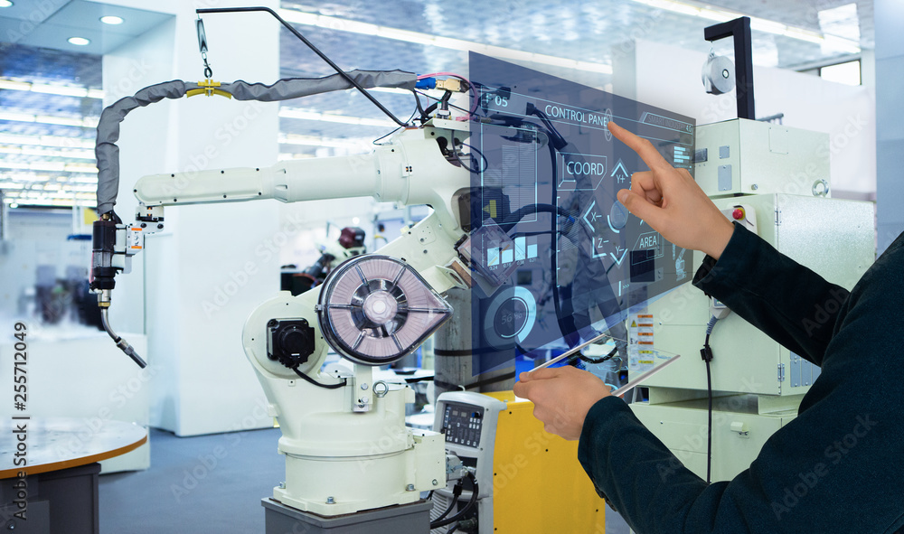 Aufkleber The engineer uses a futuristic projection touch screen to control robots in a smart factory. Smart industry 4.0 concept