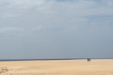 Fototapeta na wymiar minimalistic beach scene with two persons 
