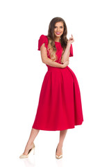 Beautiful Young Woman In Elegant Red Dress And High Heels Is Standing And Smiling