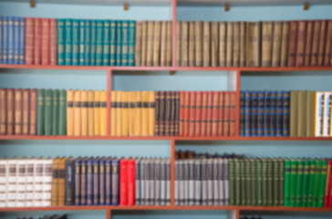 Blurred image of bookshelves in a public library. School library. Education concept