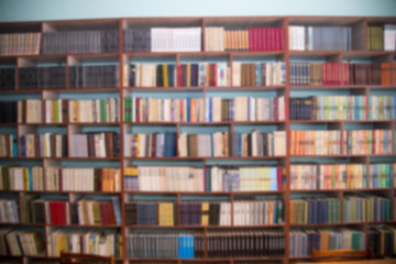 Blurred image of bookshelves in a public library. School library. Education concept