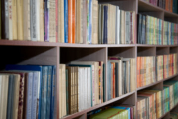 Blurred image of bookshelves in a public library. School library. Education concept