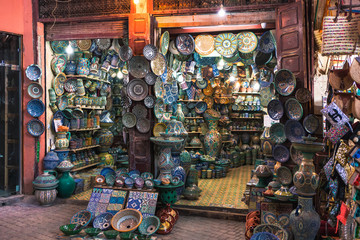 Typical Moroccan shop in the souks of the Medina of Marrakesh with elaborately decorated plates and clay pots (Marrakesh, Morocco, Africa)