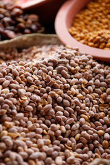 Selection of typical Moroccan nuts, walnuts, roasted almonds and other sweets being sold on a local farmer's market in the Atlas mountains (Morocco, Africa)