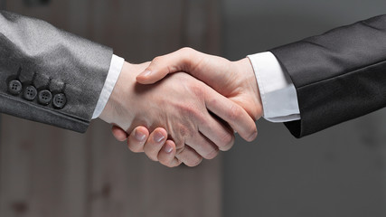 close up.handshake of business partners on a dark background