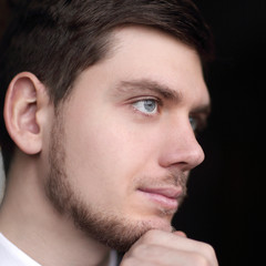 Obraz premium close up.portrait of a beautiful businessman on a dark background