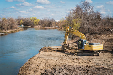 Fototapeta na wymiar a large dredger prepares the land for the construction of a bridge