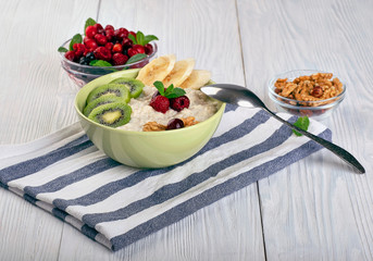 porridge with fruit on wooden background