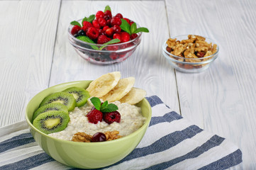 porridge with fruit on wooden background