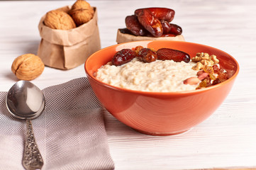 porridge with fruit on wooden background