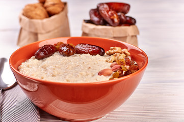 porridge with fruit on wooden background