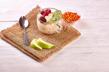 porridge with fruit on wooden background