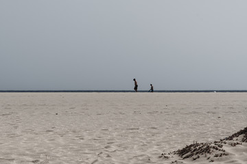 minimalistic scene on the beach with real people