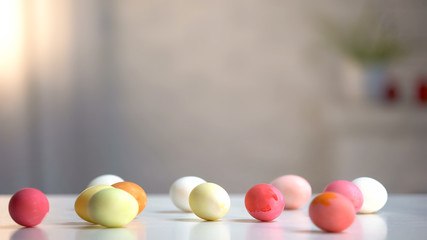Dyed eggs lying on table, preparation for religious holiday, Easter celebration