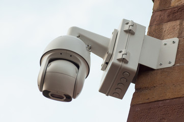 closeup of white security cameras of security on stoned wall