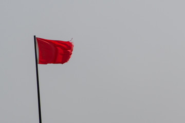 red flag sign on the beach 