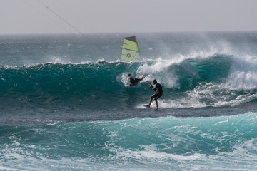 surfer against a deep blue wave 