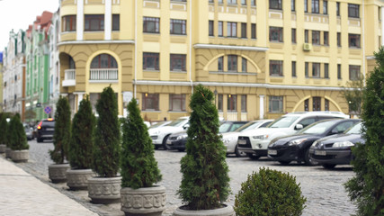 Fototapeta na wymiar View to modern facade of building and fashionable expensive cars in parking lot