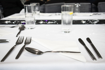 Cutelry set out ready for a meal set on a table for a party