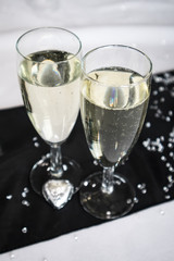 A pair of champagne flute glasses with sparkling drink in ready for celebration or toast