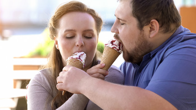 Obese Loving Couple Sharing Ice-cream, Sugary Sweet Dessert, Flirting On Date