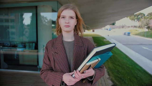 Successful and motivated female  student with big dreams studying abroad, ambitious millennial posing outdoors, creative happy manager starts successful career