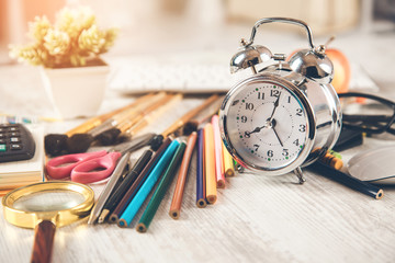 pencils with clock on desk