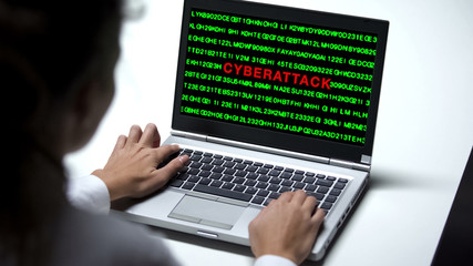 Cyberattack on laptop computer, woman working in big company office, cybercrime