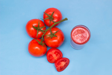 Fresh tomato juice in a glass with natural, red tomatoes. Healthy drink, Top view