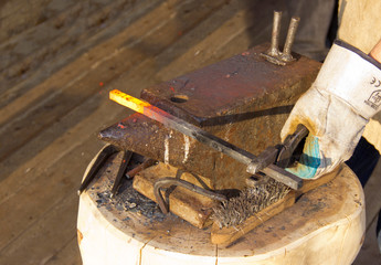 Red-hot iron on the anvil.