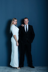 Fashionable young couple happily smiling in studio. Sexy couple. Relax, comfort lifestyle.