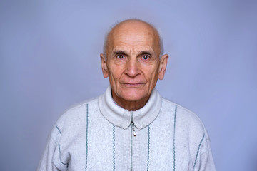 Obraz premium portrait of an old man in a warm white sweater