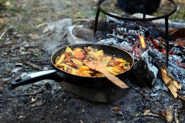 Potatoes with mushrooms and carrots in a skillet cooked in nature
