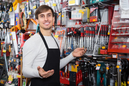 Male seller posing at tooling section