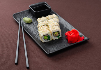 sushi on a black plate