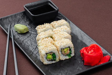 sushi on a black plate