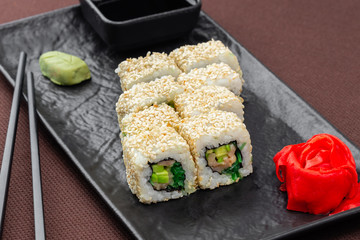 sushi on a black plate