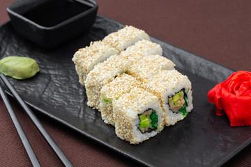 sushi on a black plate