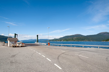 Open road. Harbor, harbour for ferries. Empty road with no traffic in countryside. Rural landscape. Ryfylke scenic route. Norway. Europe.
