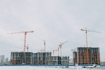 Construction of modern high-rise buildings. Phased construction of structures in winter.