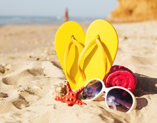 Color felt tips on sandy beach with stars, towel