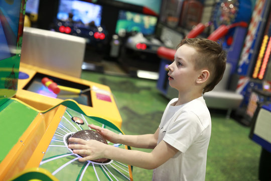 Child plays arcade game