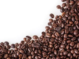 Roasted coffee beans on white background with copy space`