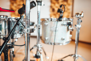 Drummer recording drum sounds, Sound recording studio.