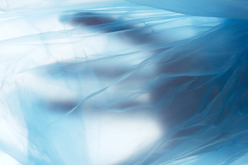 Women hand in a blue plastic bag. Concept view.