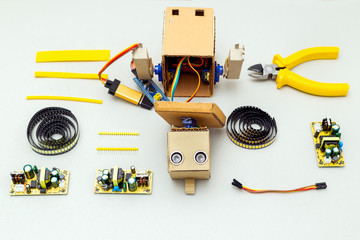  Robot with hands and tools on gray background. Flat lay