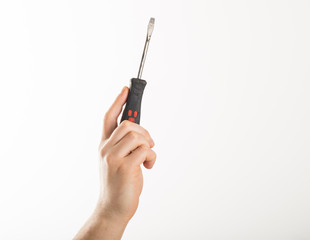 Hand holding screwdriver isolated over white background