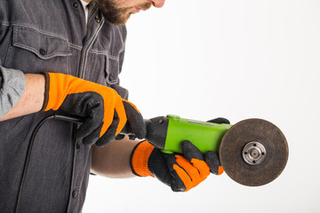 Worker is using angle grinder, hand tool, isolated over white